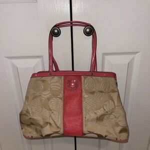 Signature Coach fabric purse with pink patent leather accents